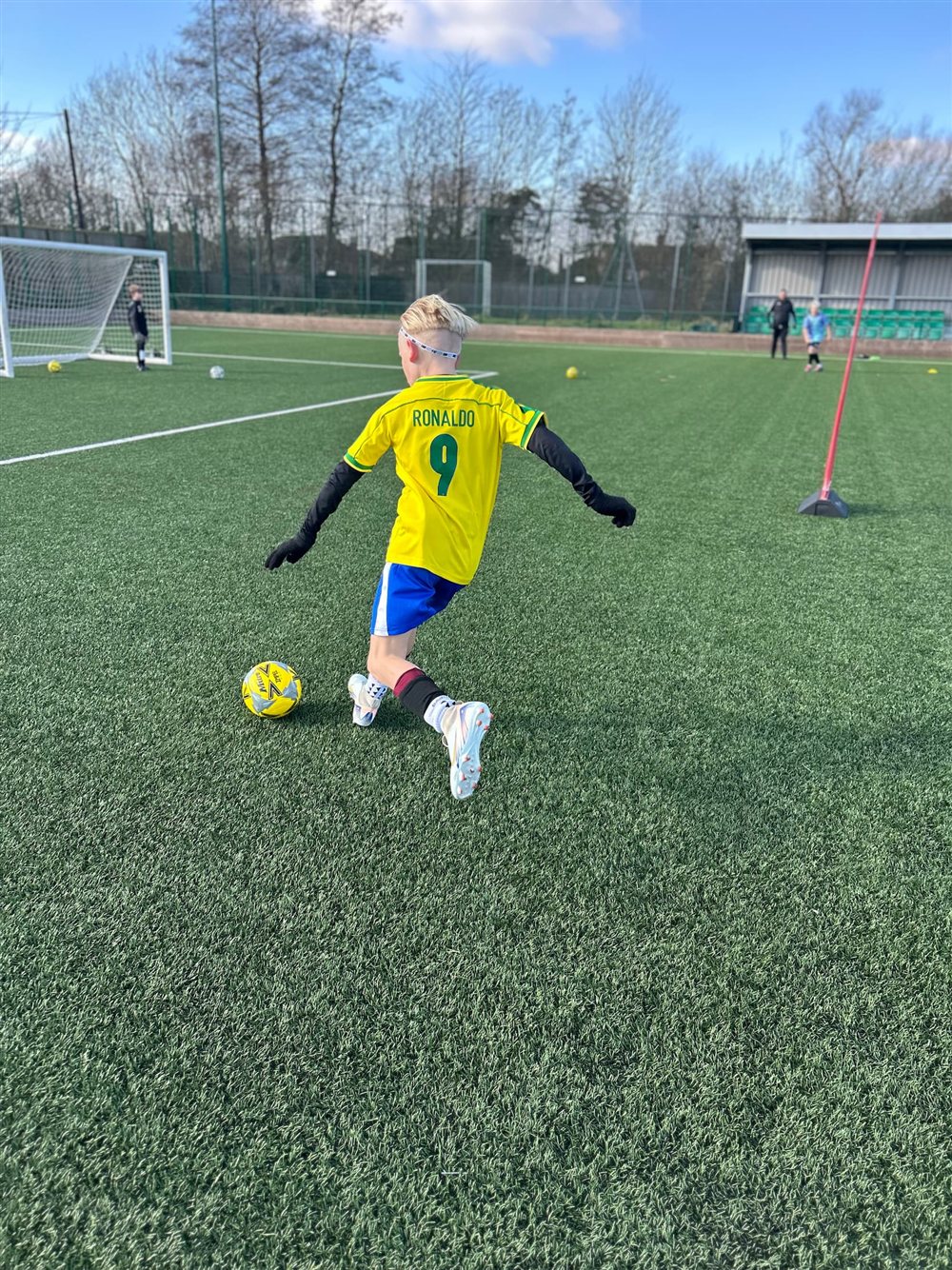 A young footballer taking a shot during a Coastal Ballers session