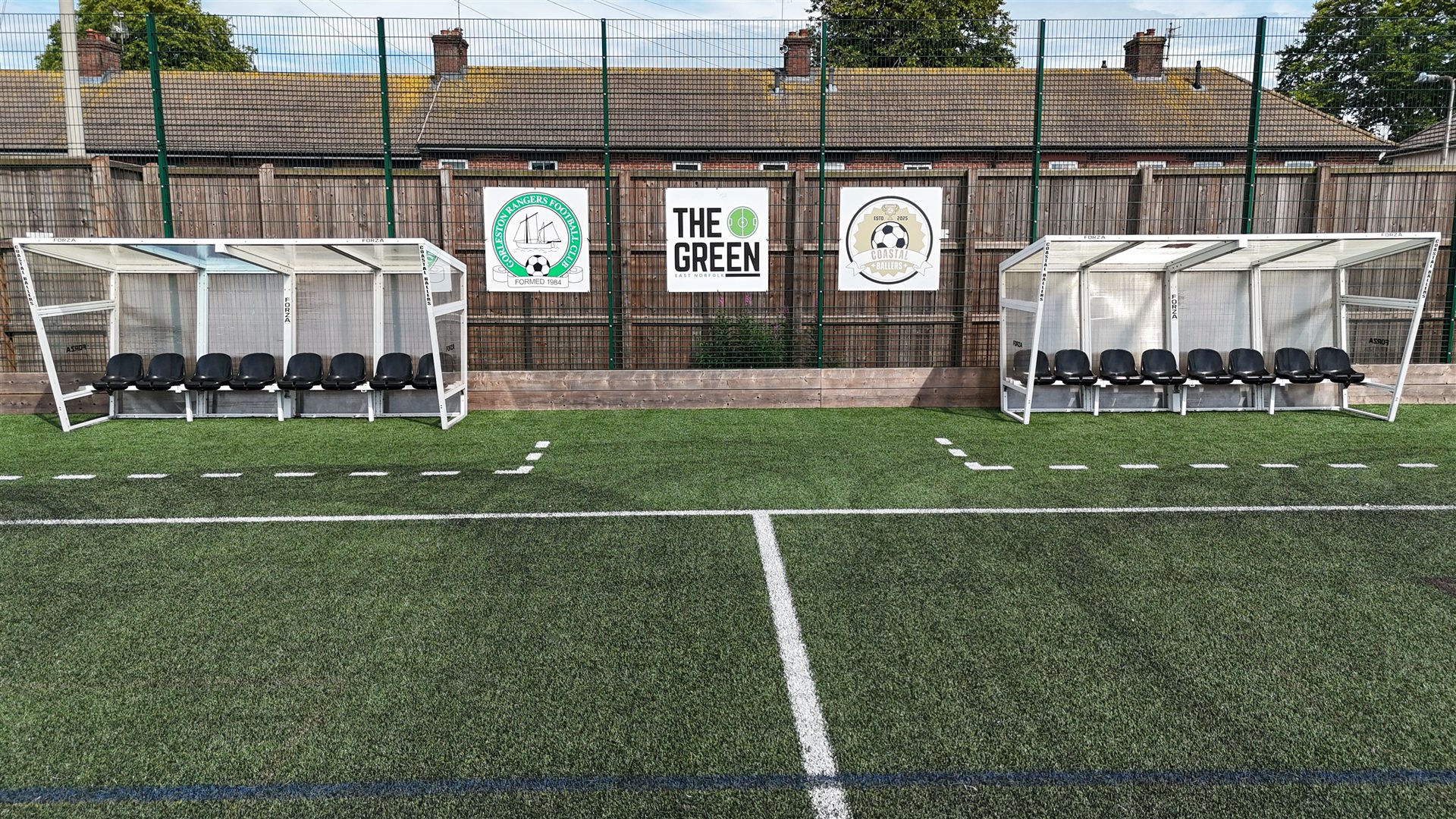 Pitch-side team shelters and Coastal Ballers signage at The Green